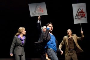 Marcus "Gee" Dahlman (Thomas Azar, center) leads protestors (Amy Resnick, left, Howard Swain, center back, and Francis Jue, right) supporting Asian American rights in the Bay Area premiere of YELLOW FACE at TheatreWorks. Photo Credit: Tracy Martin