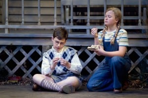 L-R Dill (Gabriel Hoffman) and Scout (Sierra Stephens) inspect a couple of pennies they found in the knothole of a tree in Christopher Sergel's adaptation of Harper Lee's timeless American classic, TO KILL A MOCKINGBIRD at TheatreWorks. Photo Credit Mark Kitaoka