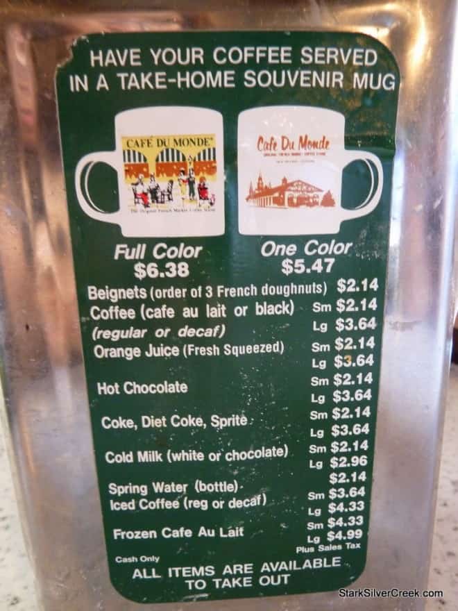 Café du Monde menu on a napkin dispenser showing coffee and beignets
