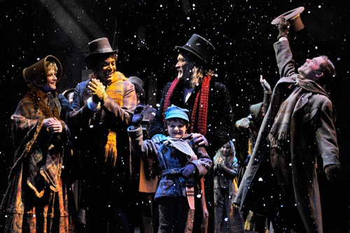 A reformed Scrooge (James Carpenter, center) celebrates the season with his nephew, Fred (A.C.T. Master of Fine Arts Program student Philip Mills, right), and the Cratchits: Bob (A.C.T. core acting company member Gregory Wallace), Anne (A.C.T. core acting company member René Augesen), and Tiny Tim (Calum John). Production photos by Kevin Berne (www.kevinberne.com)