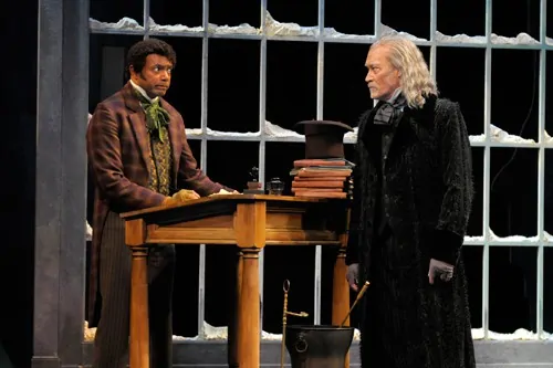 Ebenezer Scrooge (James Carpenter, right) scolds his overworked employee Bob Cratchit (A.C.T. core acting company member Gregory Wallace) on Christmas Eve. Production photos by Kevin Berne (www.kevinberne.com).