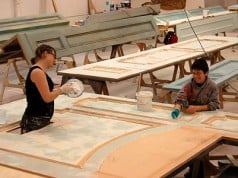 Erin Wilson and Christina Barretti-Sigal paint and distress a set wall in the scene shop at the Tony Award-winning Berkeley Repertory Theatre. Photographer: Lisa Lázár