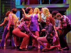 Connie Bradshaw (Julie Reiber, center, purple dress) gives newcomer Mary Ann Singleton (Betsy Wolfe, center, blue shirt) a taste of the big city in a disco. Photo by Kevin Berne.