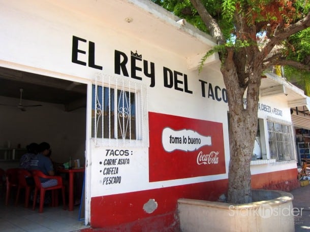 Front of El Rey Del Taco. Its distinctive red and white building is hard to miss. It does seem that Coca Cola commissioned Andy Warhol to paint this building.