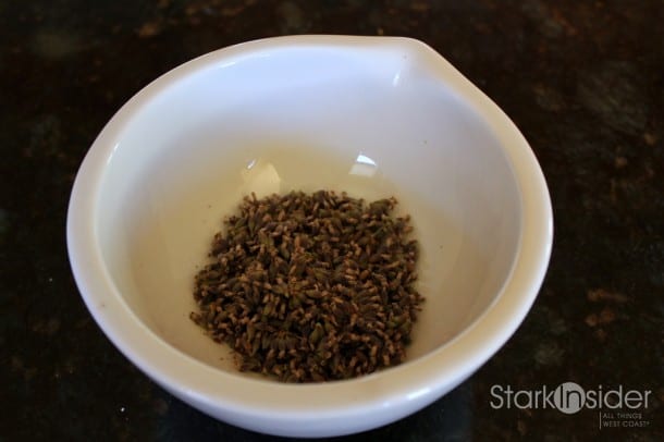 Lavender flowers are placed in a mortar.