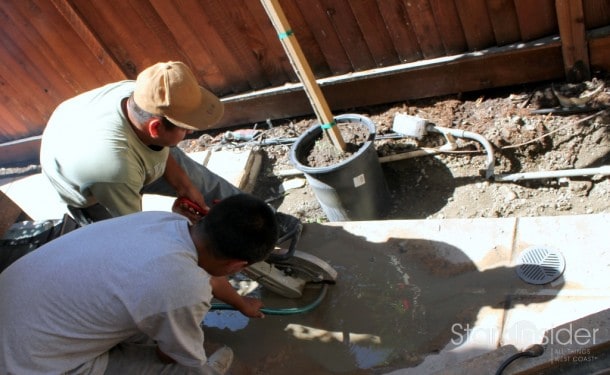 Contractors using a circular saw with concrete blade to cut the concrete. Water from a hose was used to keep the dust under control.