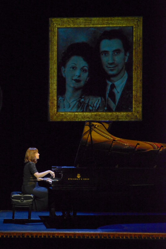 In The Pianist of Willesden Lane, award-winning pianist Mona Golabek plays the piano under a projected image of her parents, Lisa and Michel Golabek.