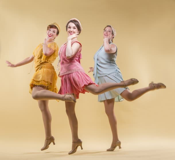 Melissa Reinertson, Jennifer Mitchell, and Andrea St. Clair kick up their heels.