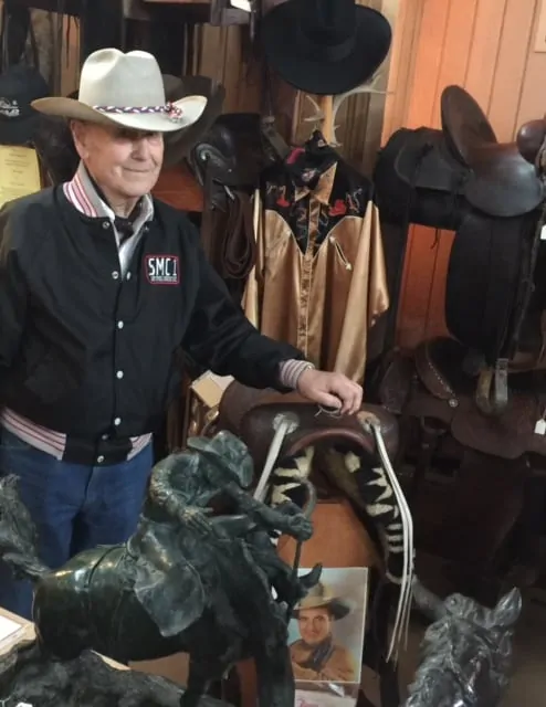 Bill Holt proudly displays Tom Mix's saddle