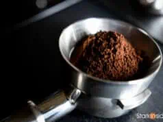 Espresso grinds in portafilter with dosing funnel