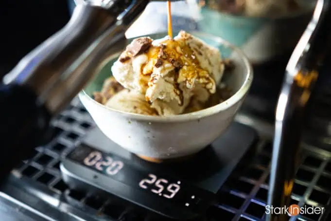 Pouring an espresso shot over an Affogato dessert.