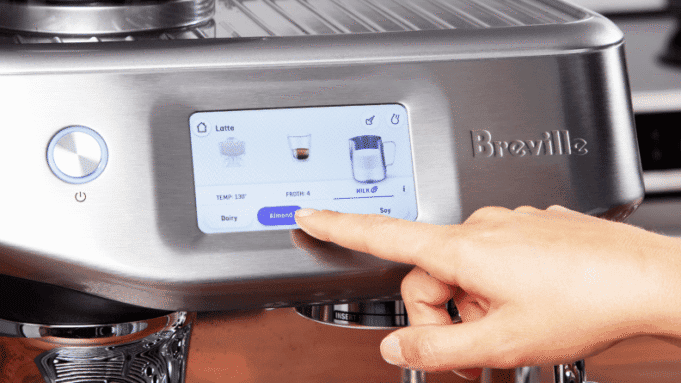 Touchscreen interface on the Breville Barista Touch Impress showing espresso, milk froth, and drink size icons.