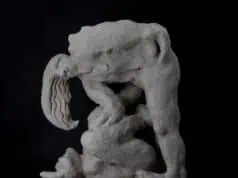Porcelain sculpture titled To Train a Minotaur by Loni Stark. Abstract, mythological figure with intertwined limbs and contorted forms, rendered in raw, textured porcelain against a dark background.