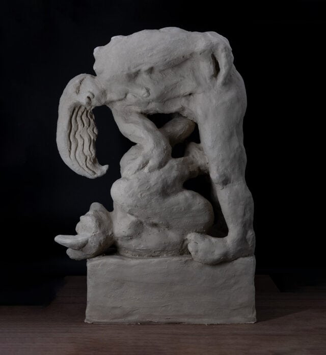 Porcelain sculpture titled To Train a Minotaur by Loni Stark. Abstract, mythological figure with intertwined limbs and contorted forms, rendered in raw, textured porcelain against a dark background.