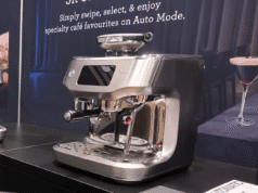 Wide shot of the Breville Oracle Dual Boiler espresso machine on a counter at a trade show
