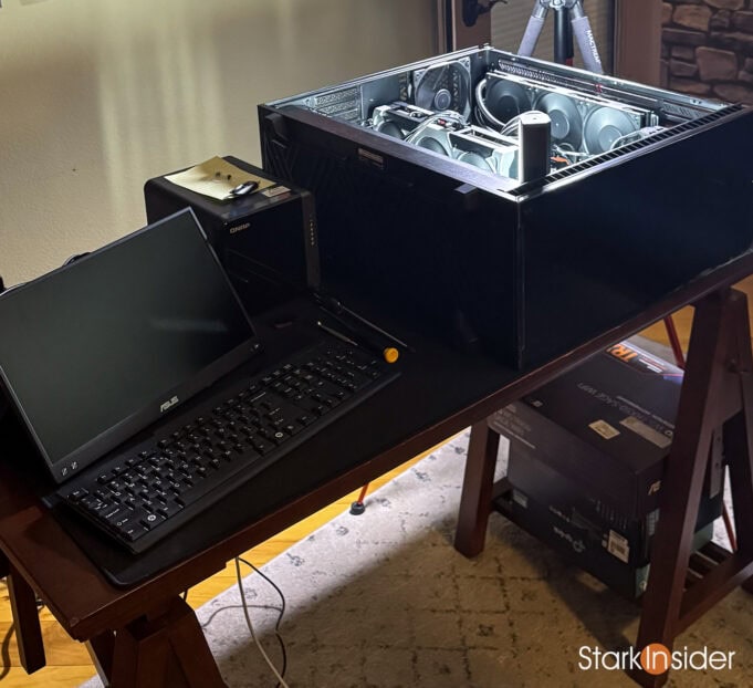 Vertigo AI server open on desk with monitor, keyboard, and lighting setup.