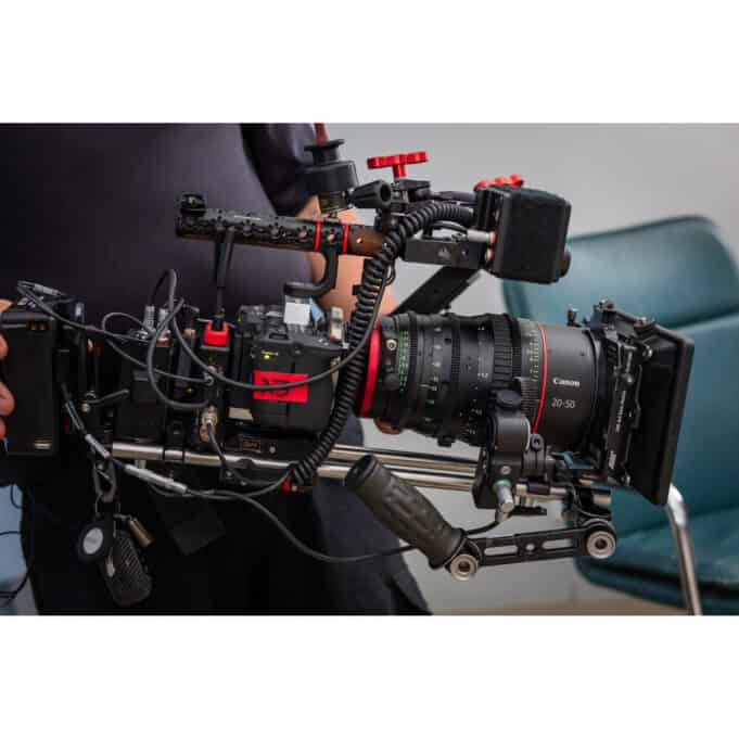 Fully rigged Canon EOS C50 cinema camera with Canon 20-50mm zoom lens, mounted on a shoulder rig with accessories.