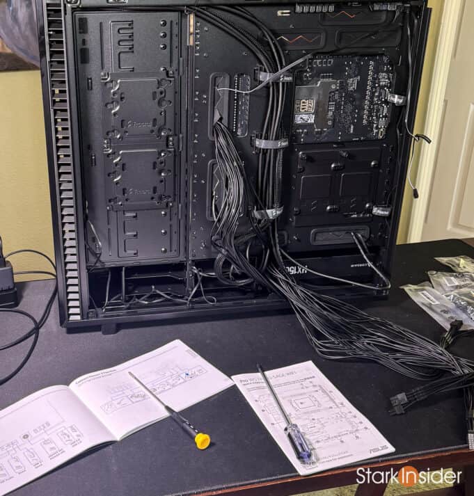 Back panel of Vertigo server case showing cable routing and manuals.