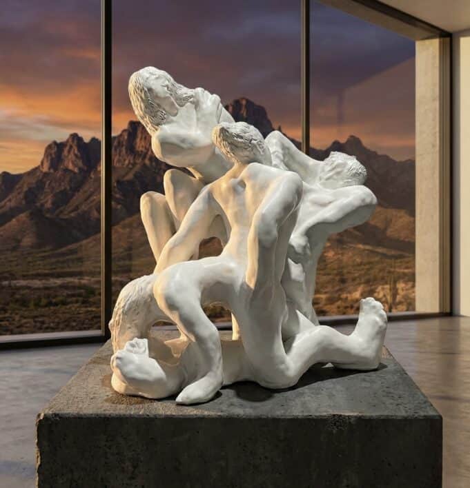 Third Mind Summit – AI × Human Collaboration Sculpture in the Loreto Desert White sculptural tangle of human figures by Loni Stark in front of desert mountains at sunset, artwork for the Third Mind AI–human collaboration summit
