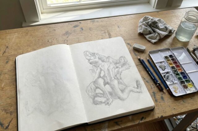 Artist’s sketchbook open on a wooden desk, exploring creativity and human–AI collaboration ahead of the Third Mind AI Summit