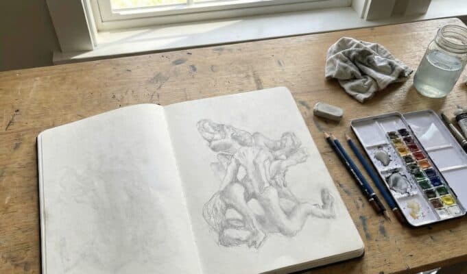 The Memento Problem: Notes on AI, Memory, and The Third Mind Summit Artist’s sketchbook open on a wooden desk, exploring creativity and human–AI collaboration ahead of the Third Mind AI Summit