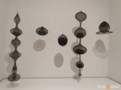 The Wire Remembers Six Ruth Asawa looped-wire sculptures suspended against white wall with circular shadows