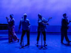 Theatre Bay Area Celebrates 50 Years of Arts Excellence Four performers stand at microphones on a stage bathed in dramatic blue lighting during a Theatre Bay Area production