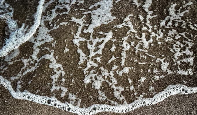 When the Summit Was Already Over: Third Mind Field Notes, Part III Loreto Bay written in sand being washed away by ocean wave - metaphor for ephemeral nature of human-AI collaboration summit